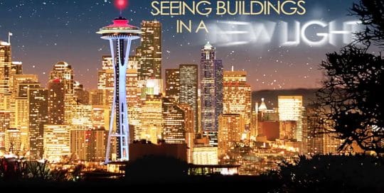 Bobrick Closing Video from 2008 conference, video thumbnail features the Seattle skyline at night, building are all lit with a golden glow except for the Space Needle which is blue, red and white, words in the sky read; Seeing Buildings in a New Light (video production by Merging Media).
