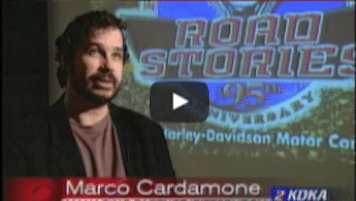 USWeb Harley Davidson News Feature thumbnail of KDKA Pittsburgh TV news station interview with Marco Cardamone, backdrop projection screen reads; Road Stories 95th Anniversary, Harley Davidson Motor Company.
