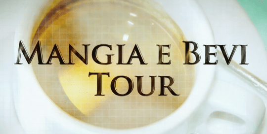Perillo Tours Mangia E Bevi Tour Commercial thumbnail features a blurred out shot of Italian espresso in a classic white porcelain cup and saucer, words in foreground read; MANGIA E BEVI TOUR (video production by Merging Media).